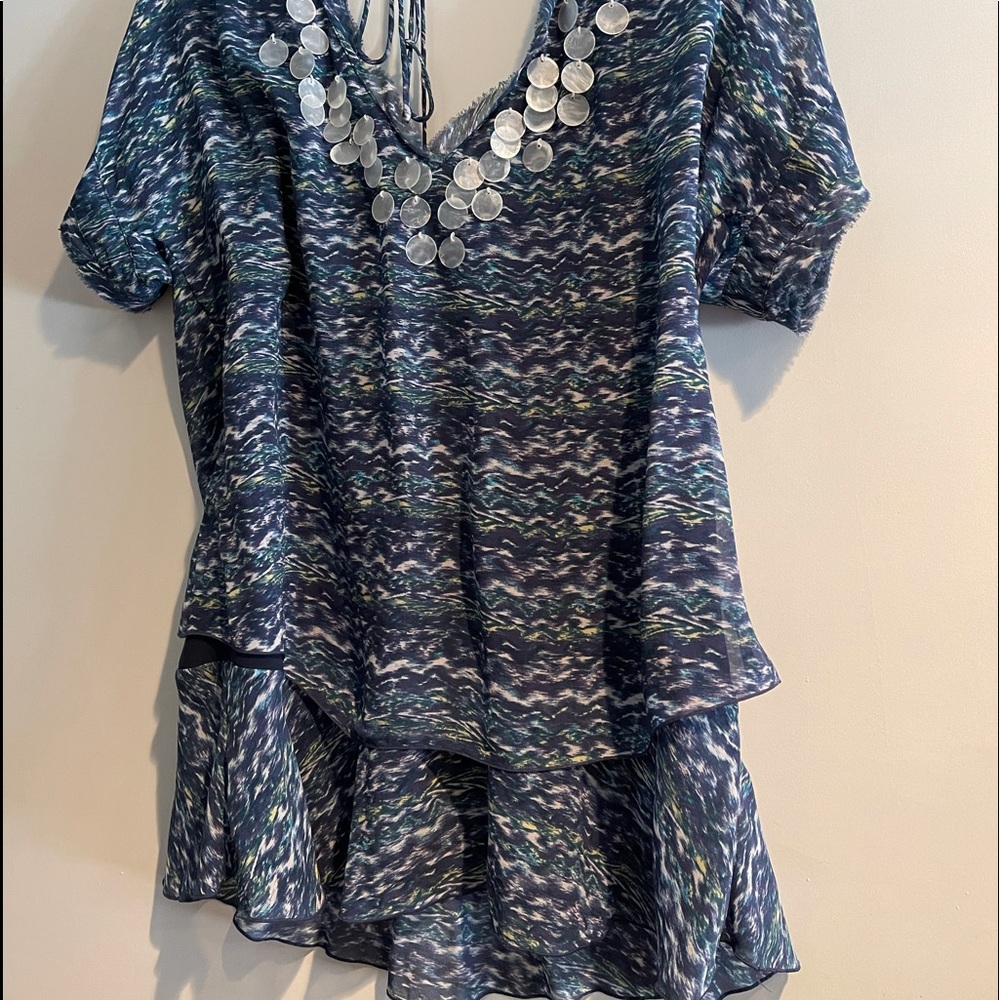 Medium size silk top with shell detail on front.